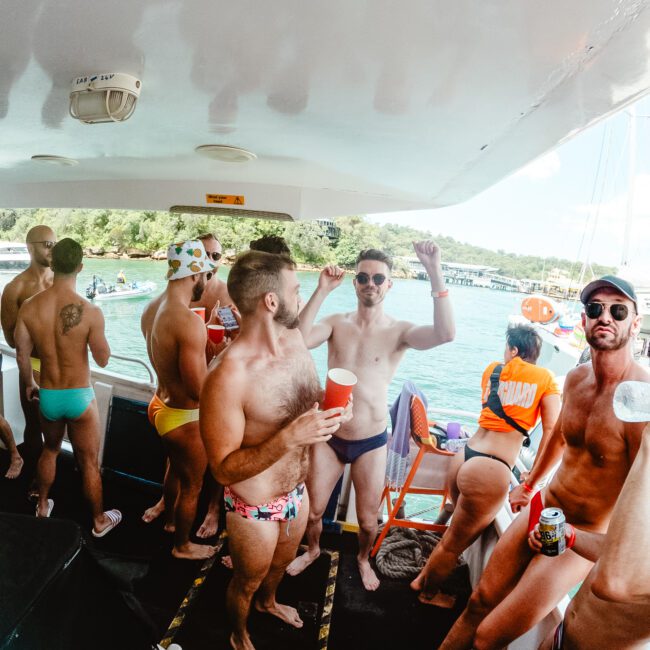 A group of people is enjoying a boat party, wearing swimwear and holding drinks. The relaxed setting features clear weather, with sparkling water and lush greenery in the background. Some are standing and socializing, while others are happily lounging around the deck.

Keywords: 
Beach, Festive

Removal: Bad, Unappealing, Useless, Horrible, Awful, Irrelevant