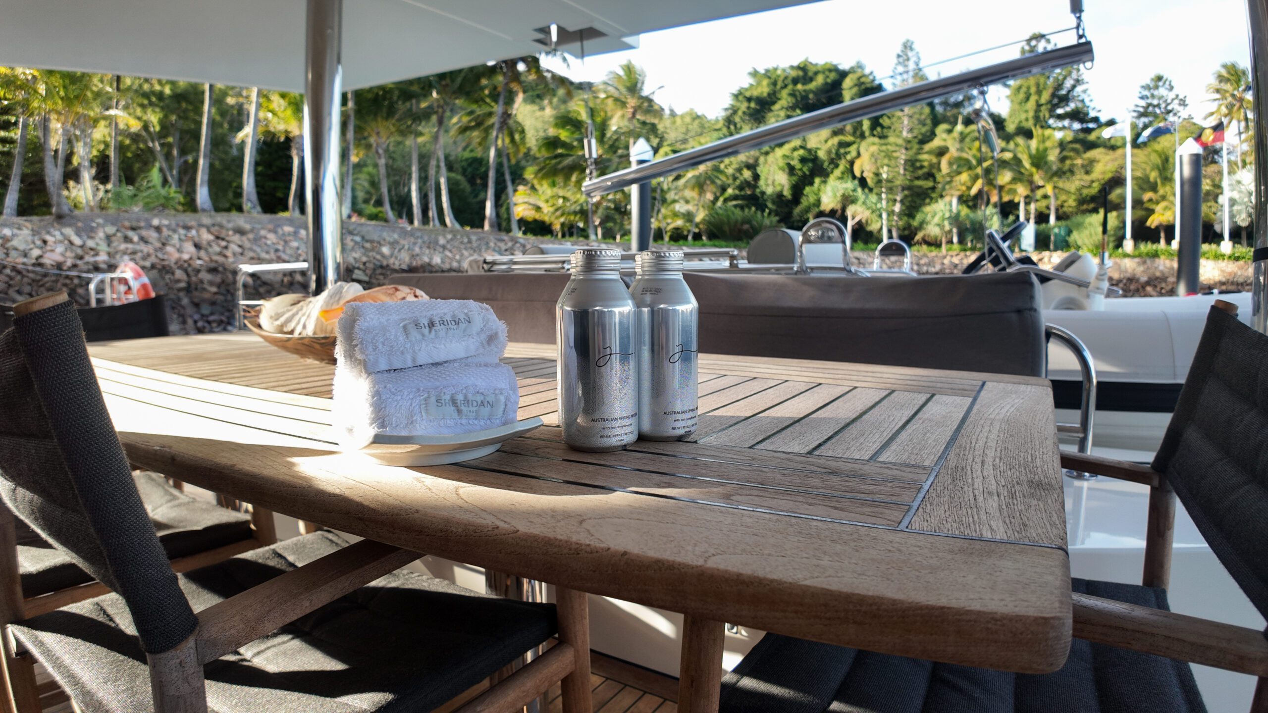 A group of silver cans on a table with towels and a towel on it.